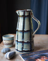 Blue/green Glazed stoneware water jug with black stripes