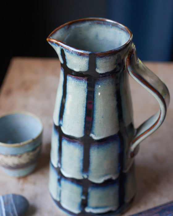 Blue/green Glazed stoneware water jug with black stripes