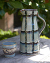 Blue/green Glazed stoneware water jug with black stripes