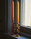 A Pair Of Amber Glass Candle Stick Holders