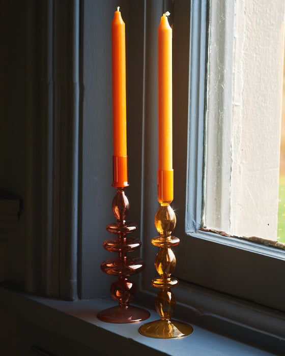 A Pair Of Amber Glass Candle Stick Holders