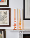 A Pair Of Amber Glass Candle Stick Holders