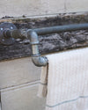 Industrial reclaimed metal towel rail 3/4-1/2 inch pipe.