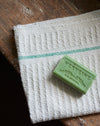 Waffle hand towel with green stripe