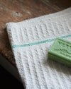 Waffle hand towel with green stripe