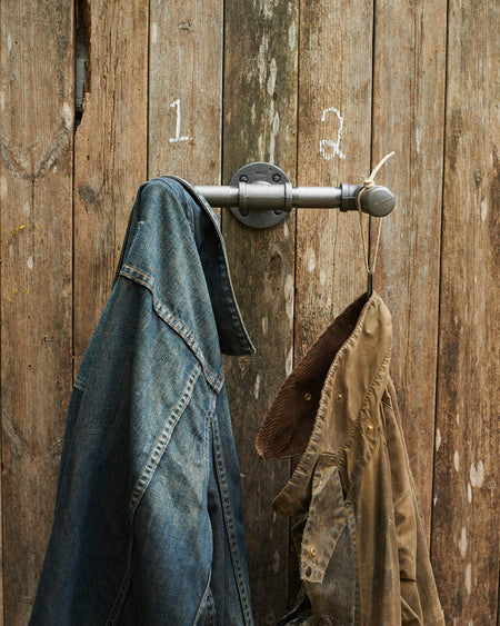 Industrial grey steel hanging hooks in 3/4 inch pipe.