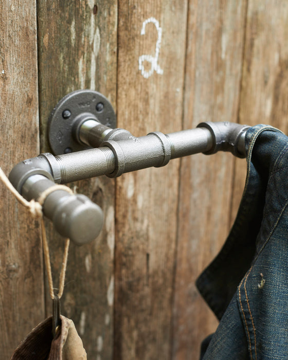 Industrial grey steel hanging hooks in 3/4 inch pipe.