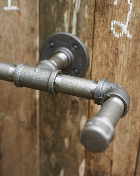 Industrial grey steel hanging hooks in 3/4 inch pipe.