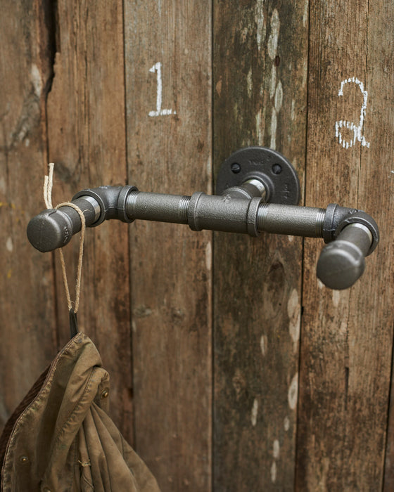 Industrial grey steel hanging hooks in 3/4 inch pipe.