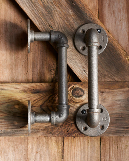 A pair of heavy duty industrial metal door handles