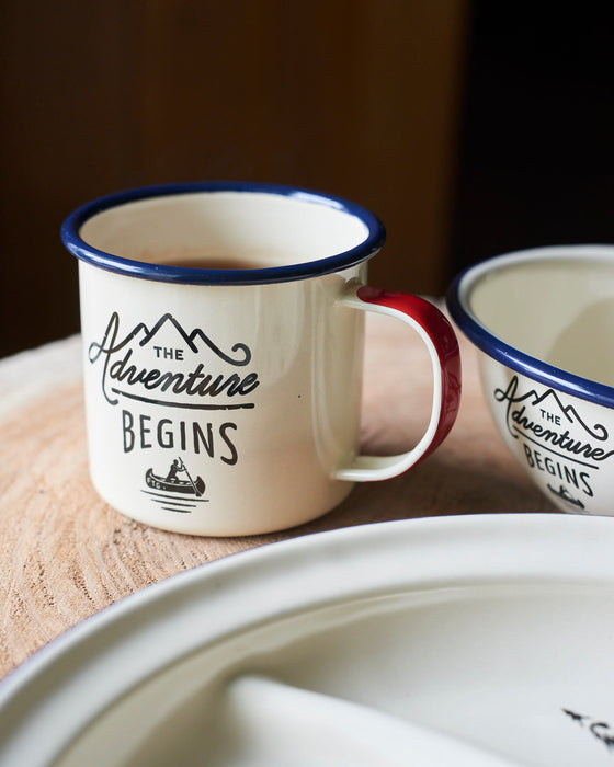 Enamel Adventure camping plate with blue trim.