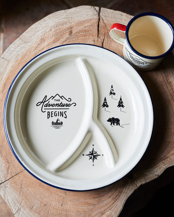 Enamel Adventure camping plate with blue trim.