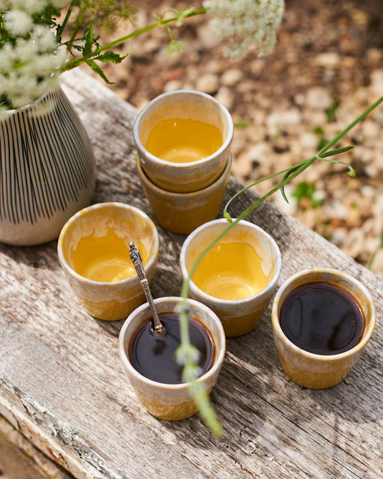 Ceramic espresso cups in a Mediterranean yellow and cream glaze.