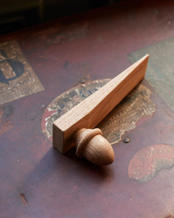 Solid Oak door wedge with turned acorn. Made in the UK