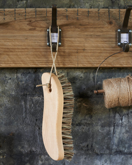 S - shaped oiled beechwood scrubbing utility brush.