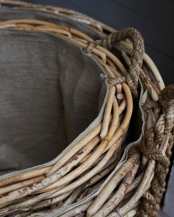 Large rattan log baskets with rope handles