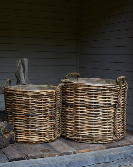 Large rattan log baskets with rope handles