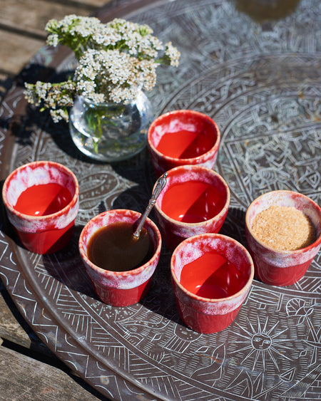 Ceramic espresso cups in a Mediterranean flame red and cream glaze.
