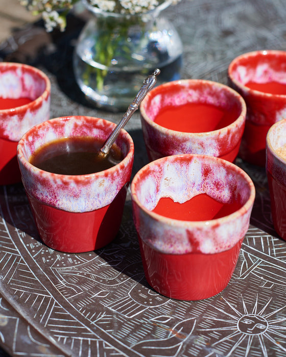 Ceramic espresso cups in a Mediterranean flame red and cream glaze.