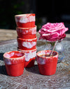 Ceramic espresso cups in a Mediterranean flame red and cream glaze.