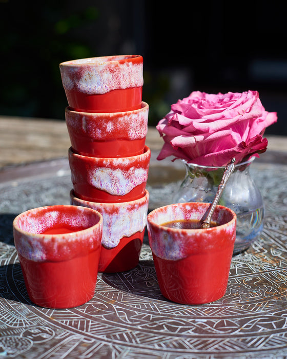 Ceramic espresso cups in a Mediterranean flame red and cream glaze.