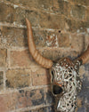 Decorative silver faux bull skull with carved wooden horns.