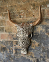Decorative silver faux bull skull with carved wooden horns.